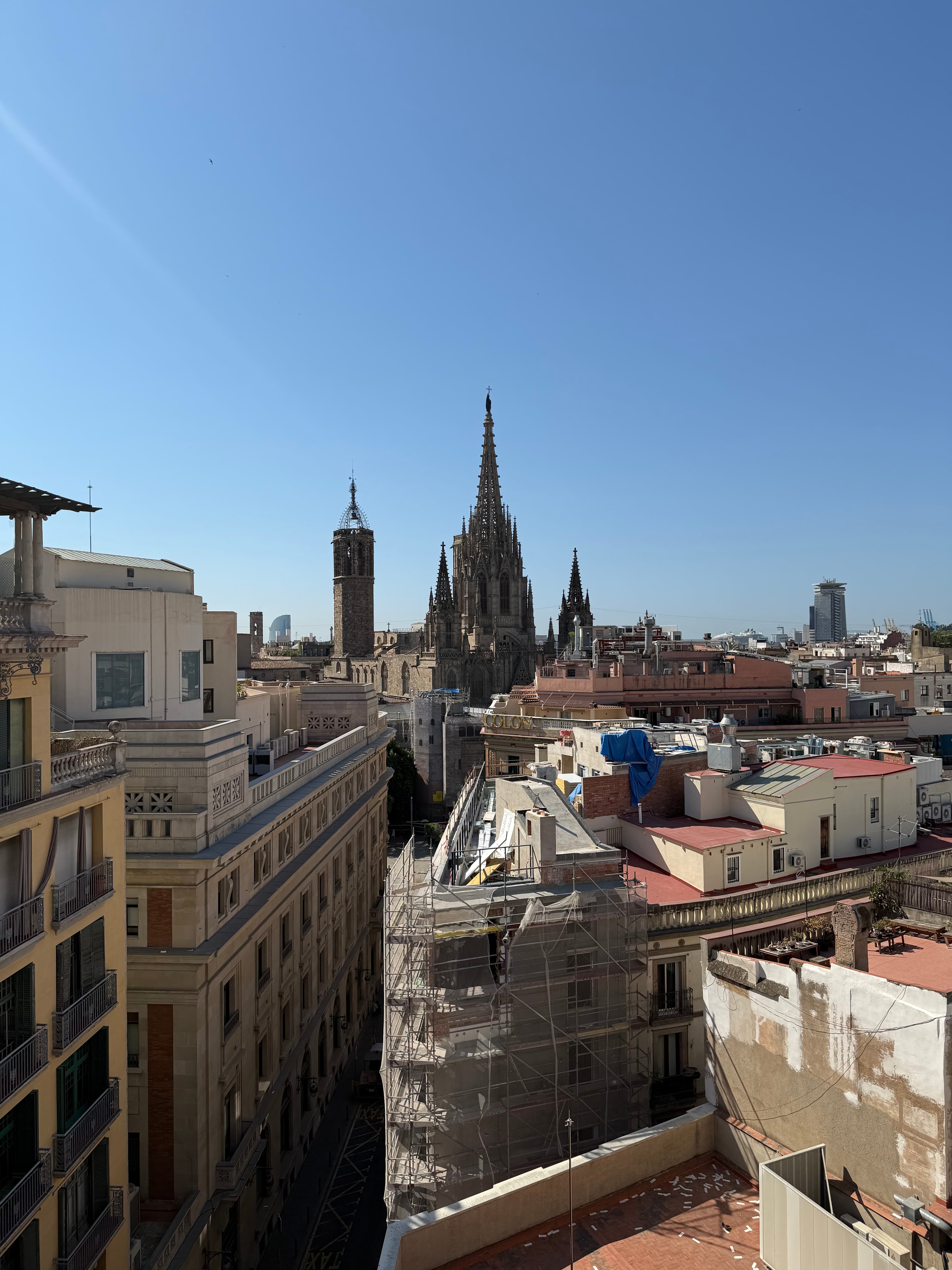 Rooftop view over Barcelona's Gothic Quarter with Barcelona Cathedral's ornate spires rising above densely packed historic bu